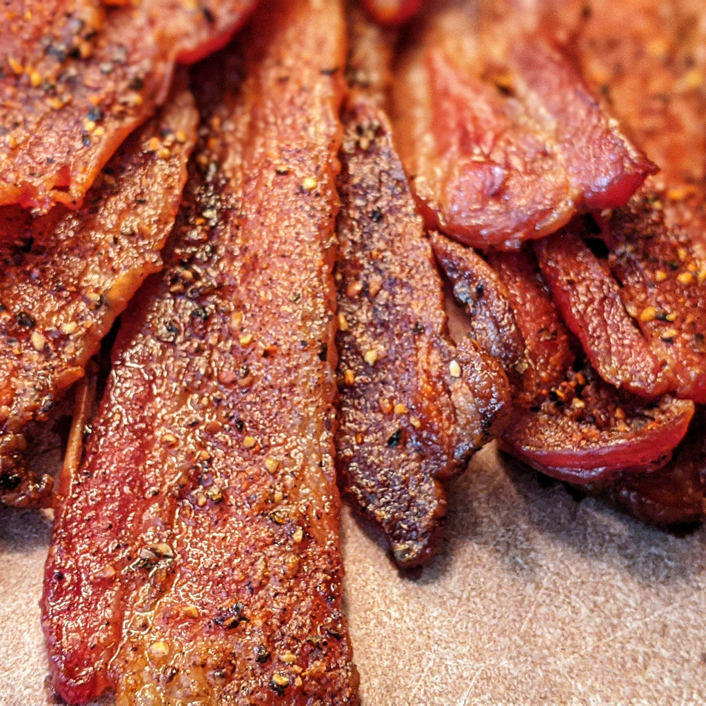 Dr. Bacon O.G. Spice Rub seasoned thick cut bacon strips.