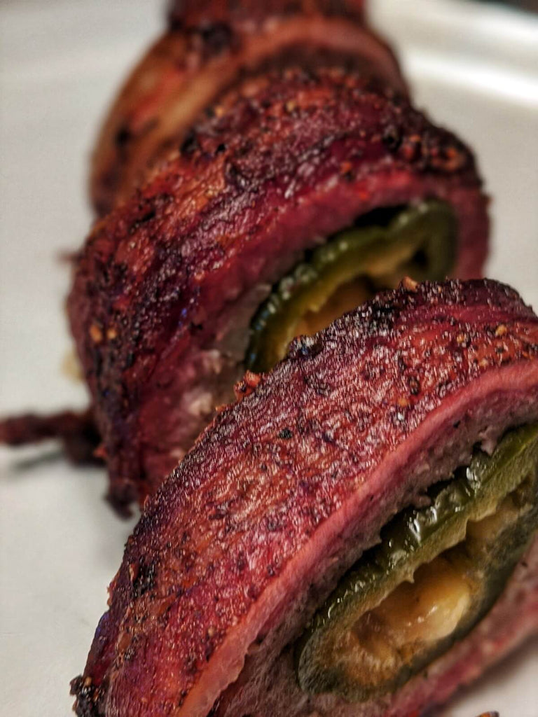 Dr. Bacon Smoked bacon wrapped cheese stuffed jalapenos cut like a sushi roll.