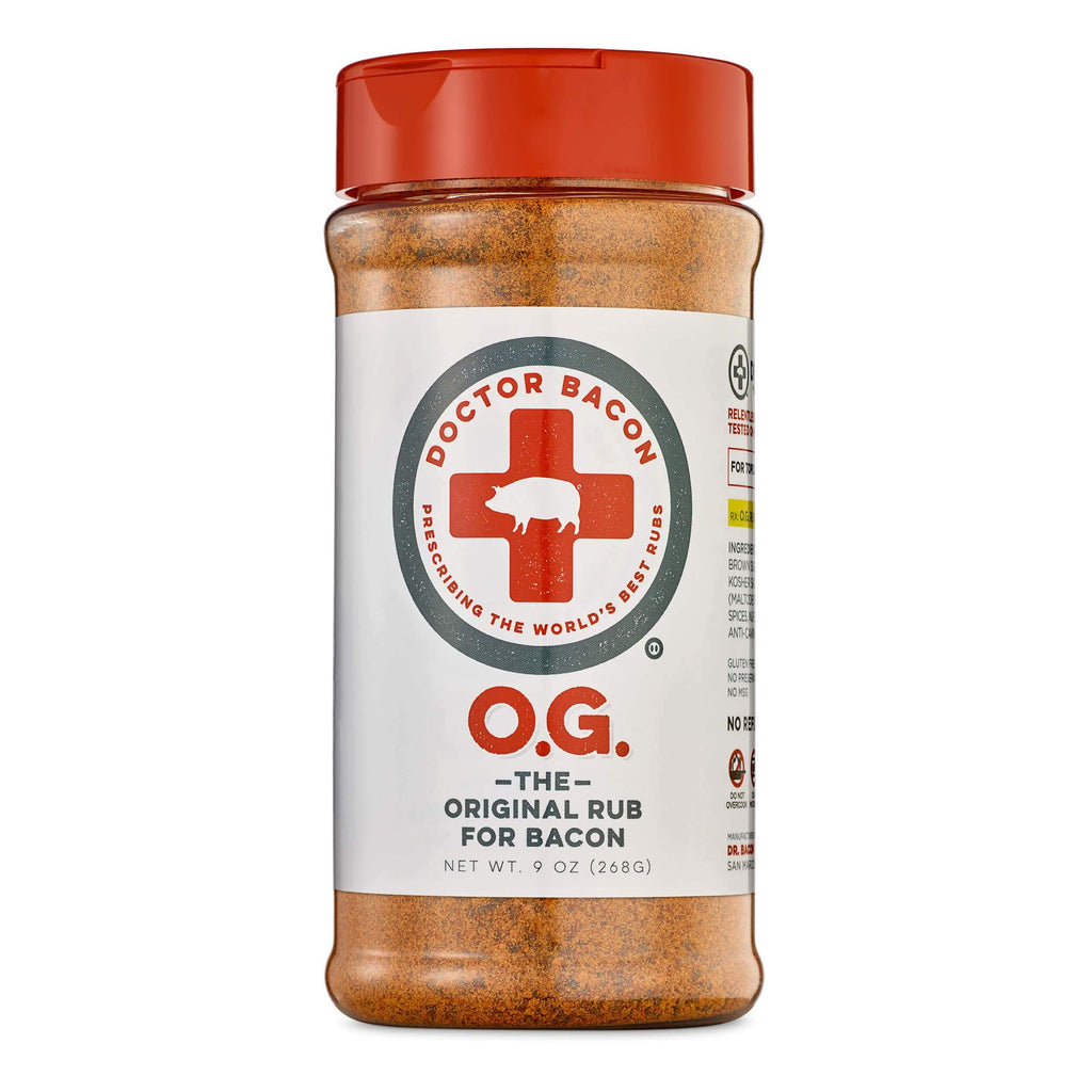 Bottle of DR. BACON O.G. SPICE RUB- white label with red and charcoal graphics. Red Cap. Filled with spices, chilies, peppers. On a white background.